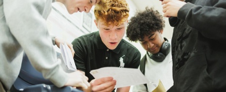 Image of past students receiving their GCSE results